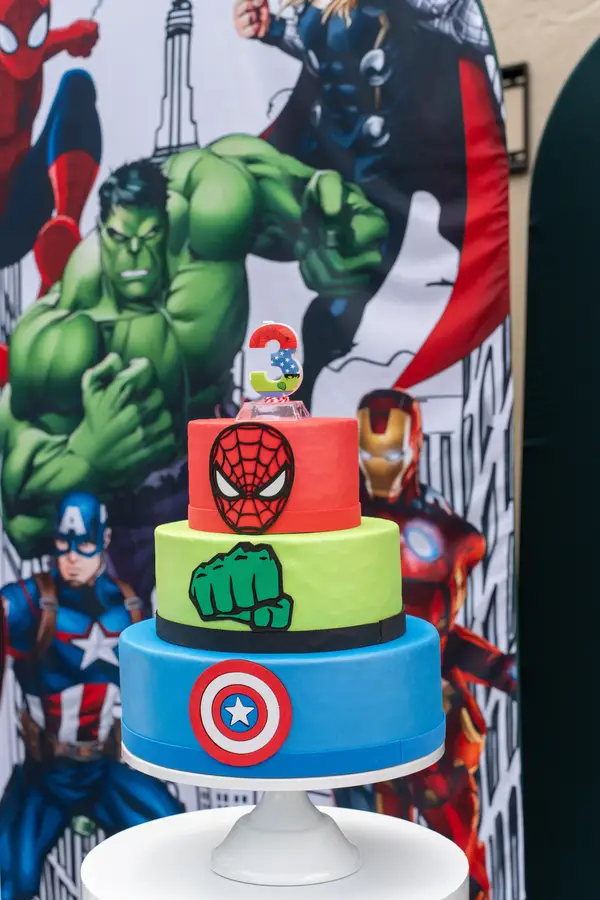 Avengers themed three-tier birthday cake with Spider-Man, Hulk, and Captain America decorations for kids party in Miami