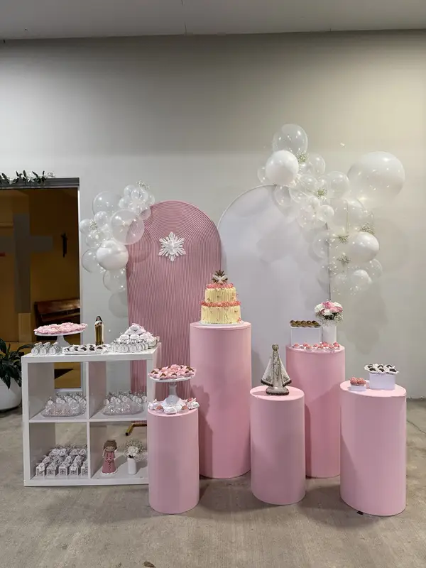 Elegant pink and white party setup with balloon arch and cylindrical pedestals for baby shower or birthday celebration in Fort Lauderdale