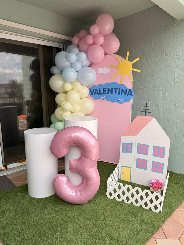 Peppa Pig themed third birthday party with pastel balloon column, pink number balloon, and personalized backdrop in Miami