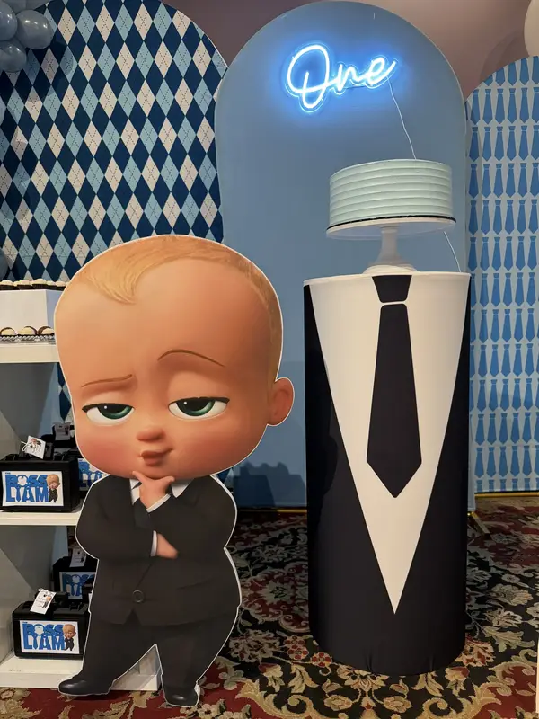 Boss Baby first birthday party setup with neon sign, blue diamond backdrop, and Boss Baby cutout decoration in Fort Lauderdale